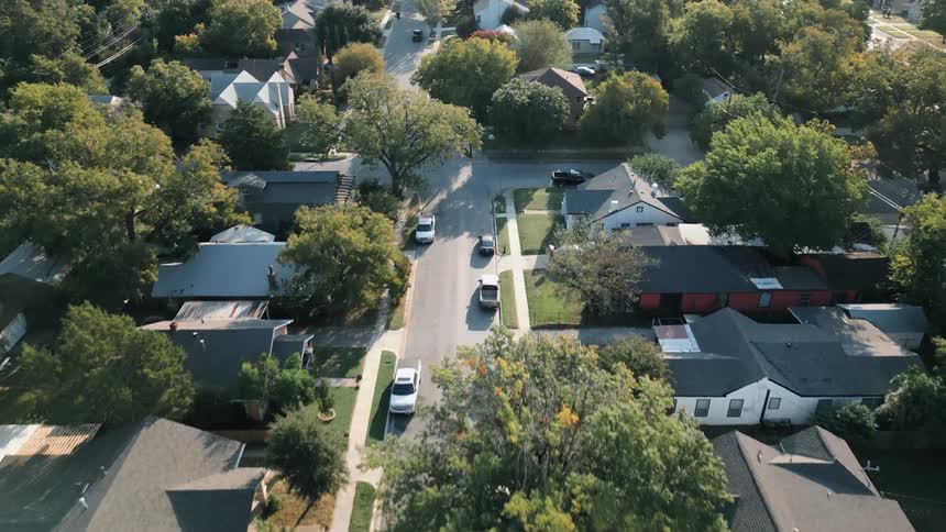 Aerial view of a suburban neighborhood with trees and houses in daylight