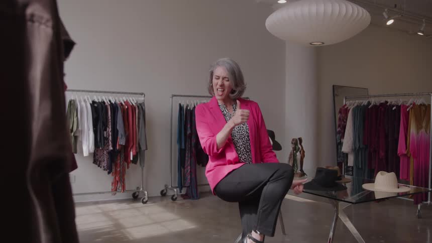 The woman laughs in the store