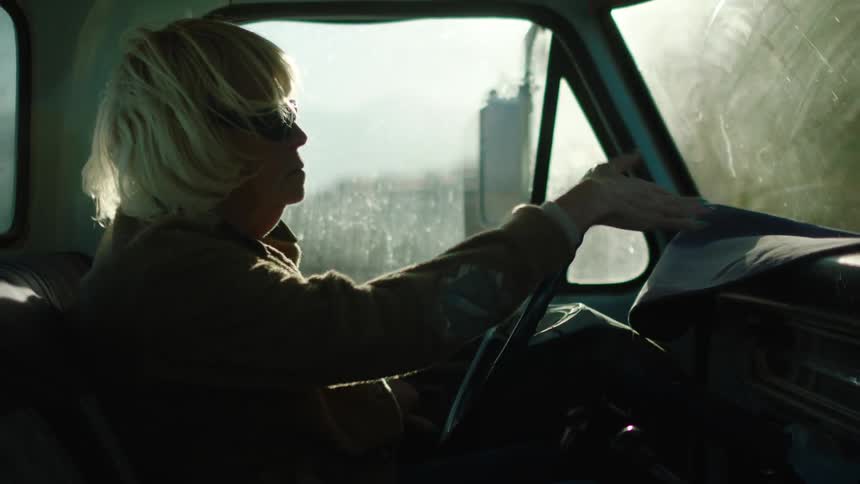 A blind woman enters vehicle and feels around the dashboard