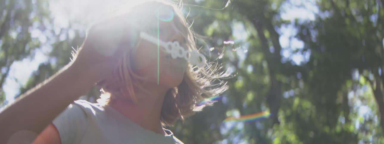 The girl is blowing bubbles on a sunny day