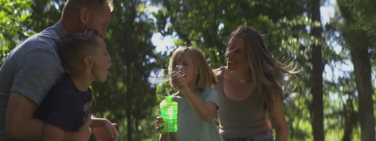 Family smiling and having fun outdoors on a sunny day