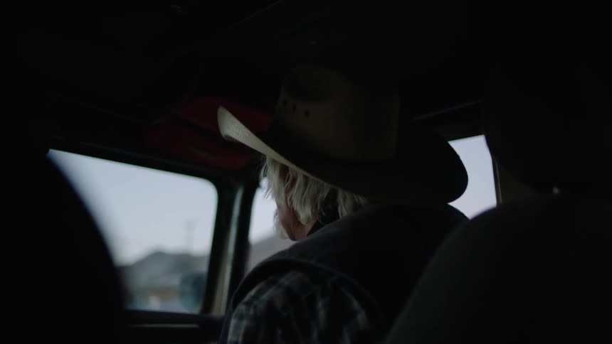 A man rides in a vehicle arguing