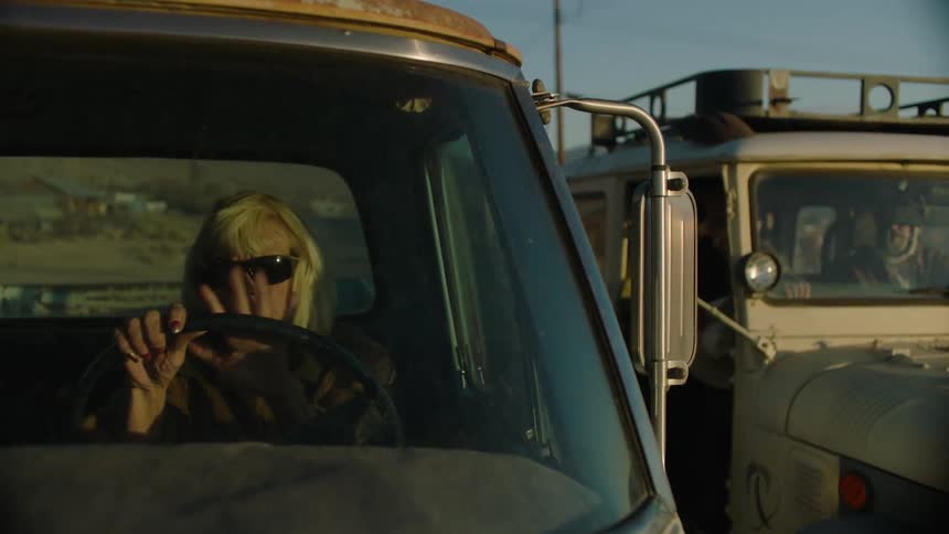 A man tries to flag down a woman driving a truck