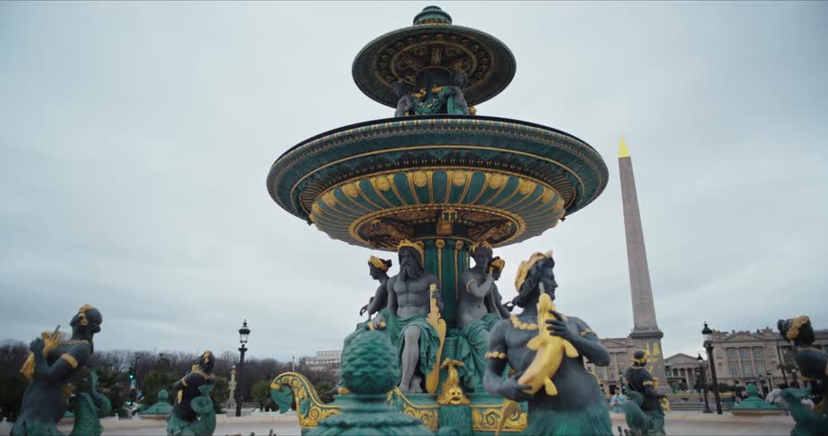 A large fountain and statues in a plaza