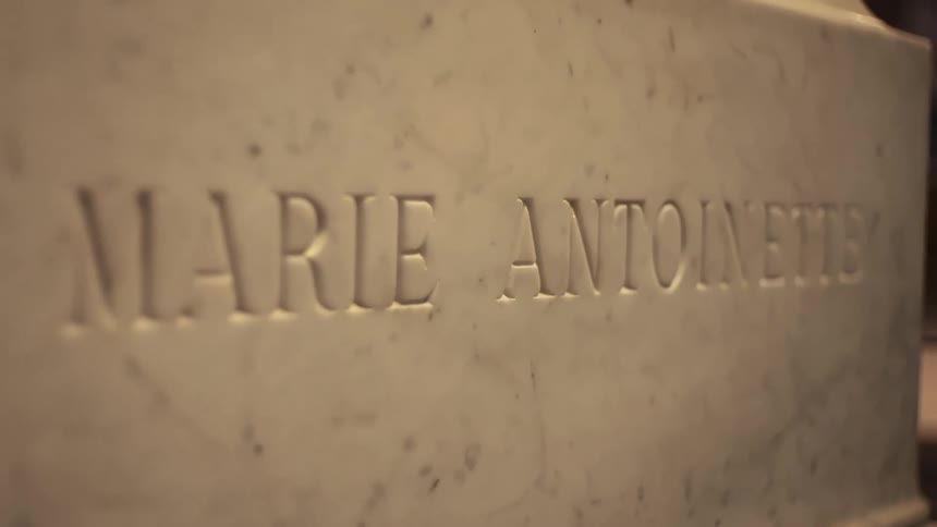 Close up of a carved gravestone bearing a persons name