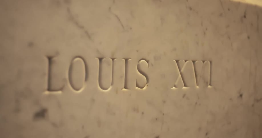 A name is carved into the marble