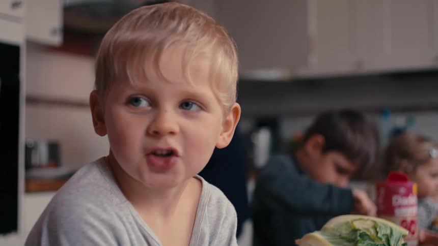 Children are eating in the kitchen