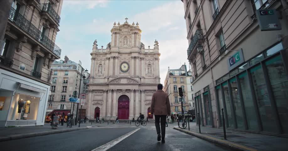 A man walks through a street in a city