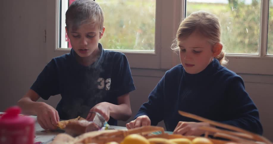 Girl burns herself on the food just served by her mother during family mealtime at home