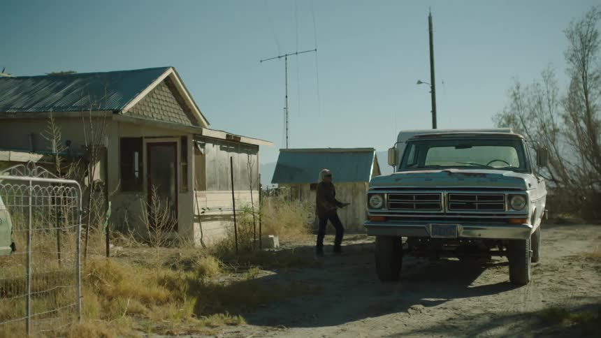 Woman walks out of her house to a pickup truck