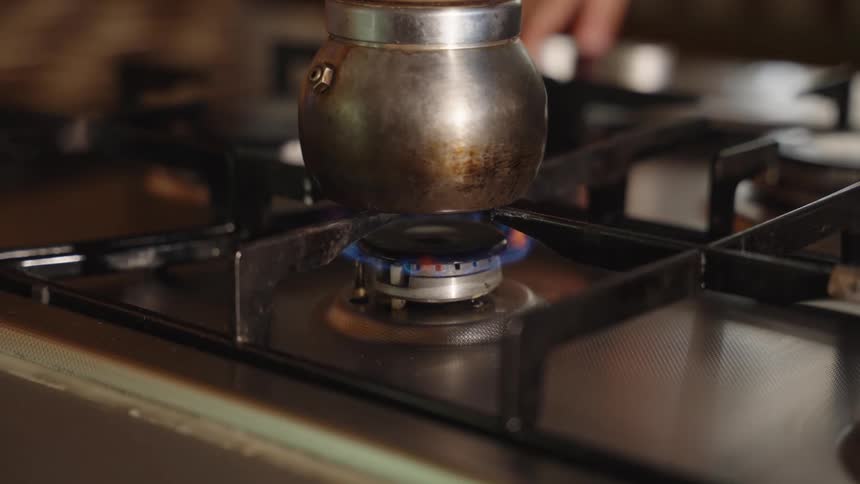 A gas burner heats up a pot