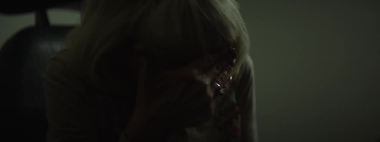 A person is sobbing in a dark room