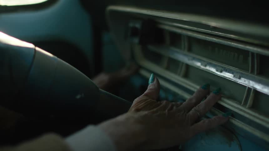 A person feels the wheel to find the ignition to put the key in
