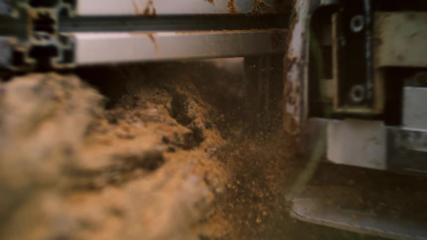 Sawdust is covering the area where the chainsaw is cutting