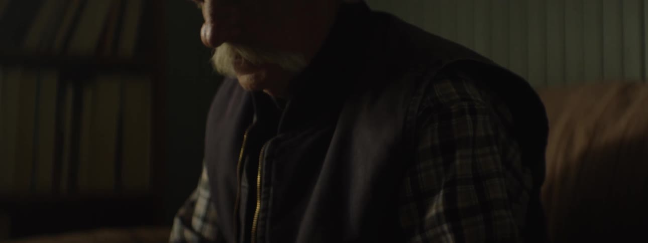 Elderly man smokes a cigarette