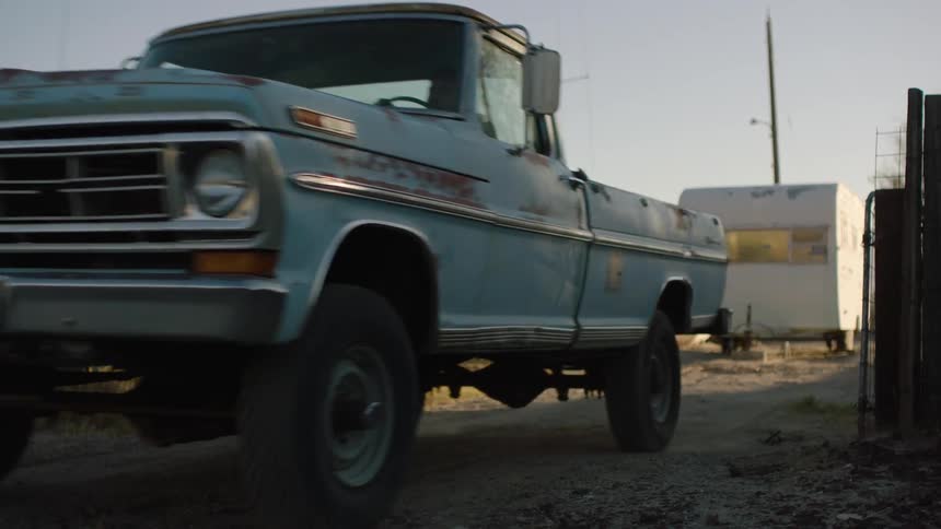 A truck drives down the small road