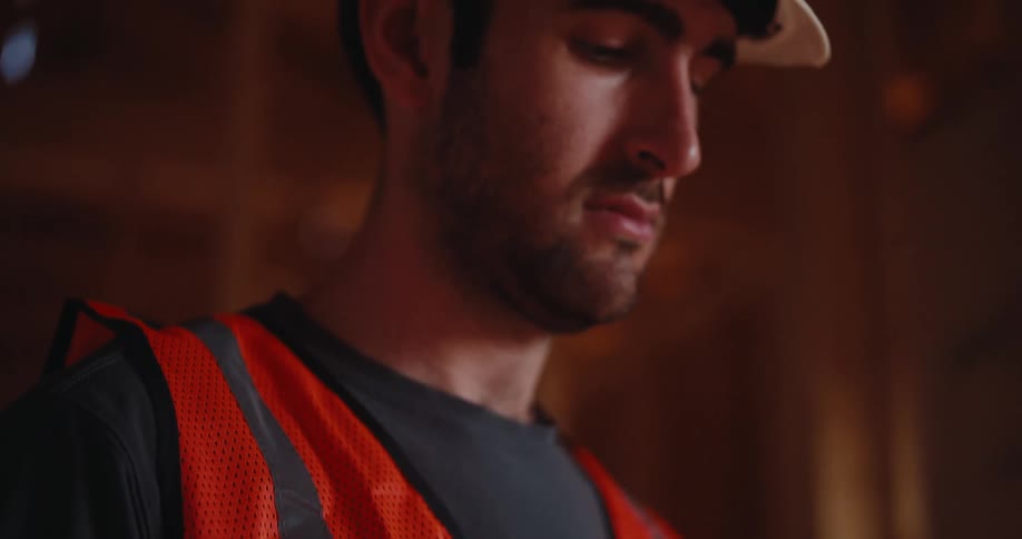 A carpenter looks at a tablet