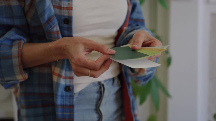 A woman shuffles paint chips in her hand
