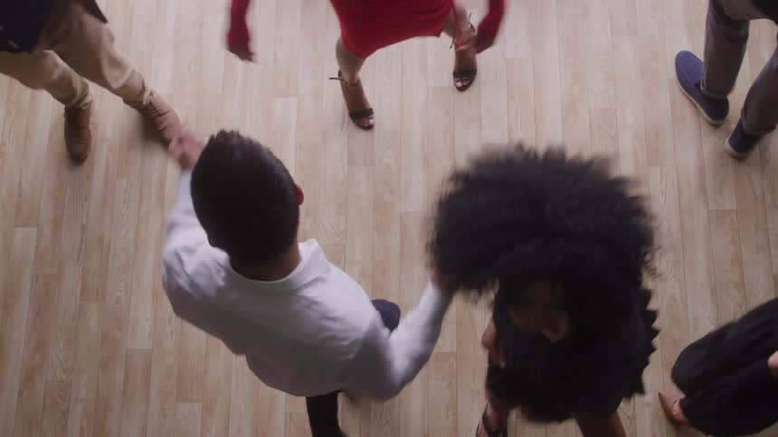 Small group of young people from different ethnicities dancing indoors during day time