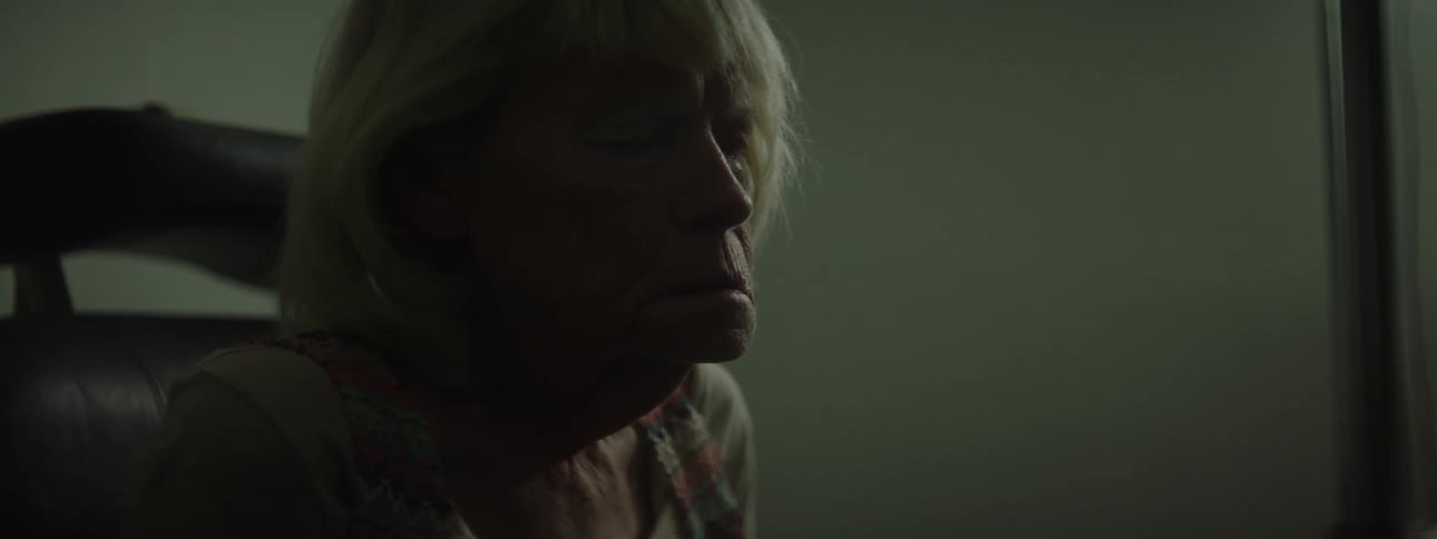 An older woman at the eye doctor sighs and shakes her head