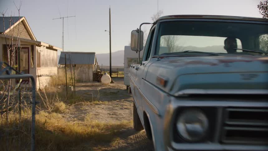 Person drives away in an old pickup truck