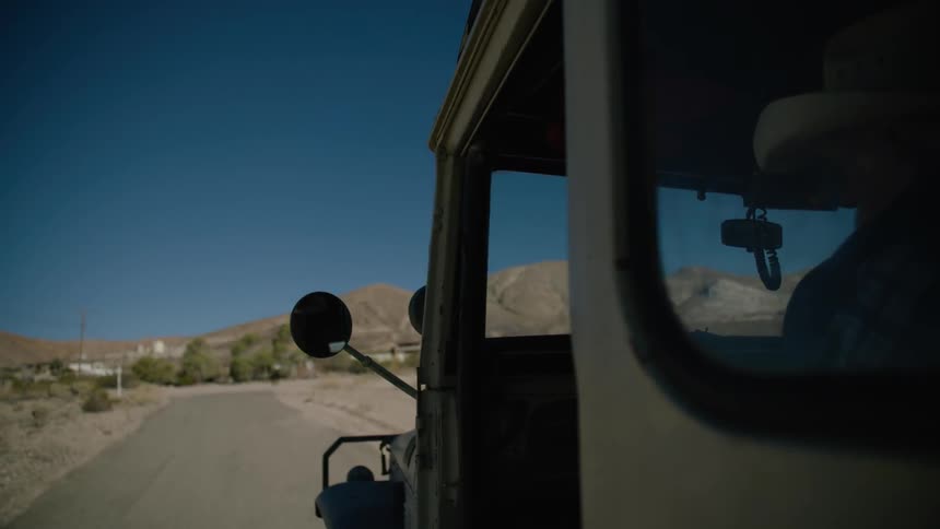A truck travels around a corner on a road