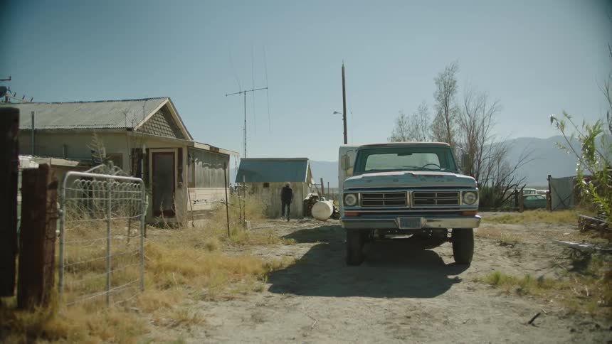 Person walks outside on property in a rural area