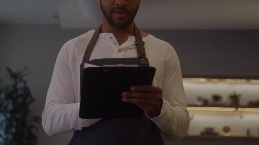A small business owner taking notes while working in cafe