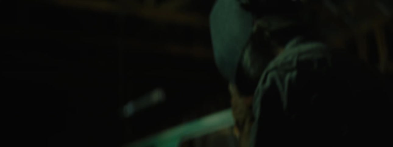 Man welding in shop stops to look at blinking lights on ceiling