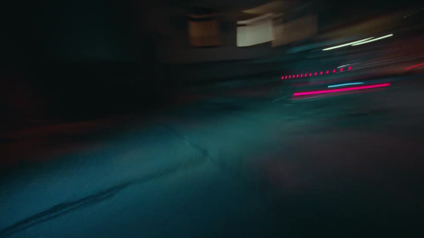Cyclists in motion at night with highlighted blue lights