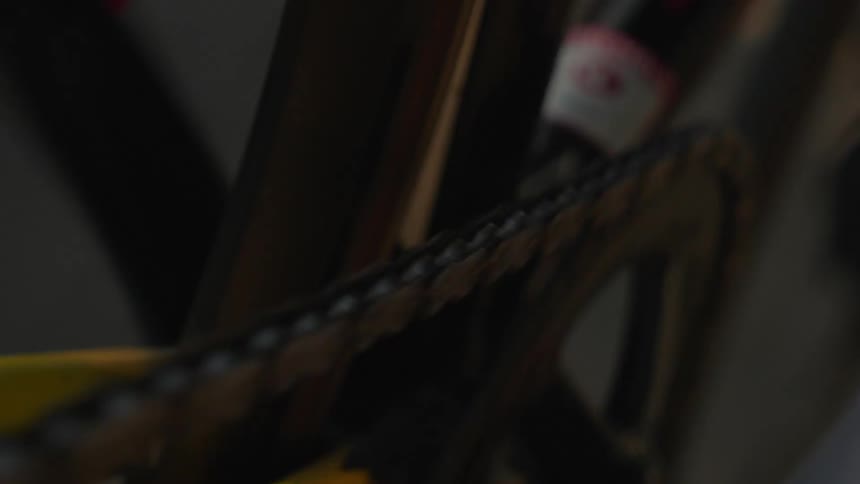 Bicycle chain in motion under warm light