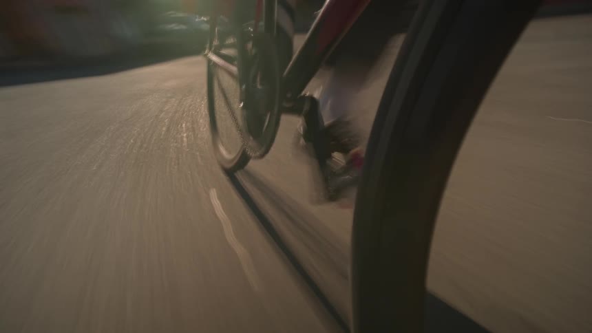 Pedal in motion of a bicycle captured from a low angle