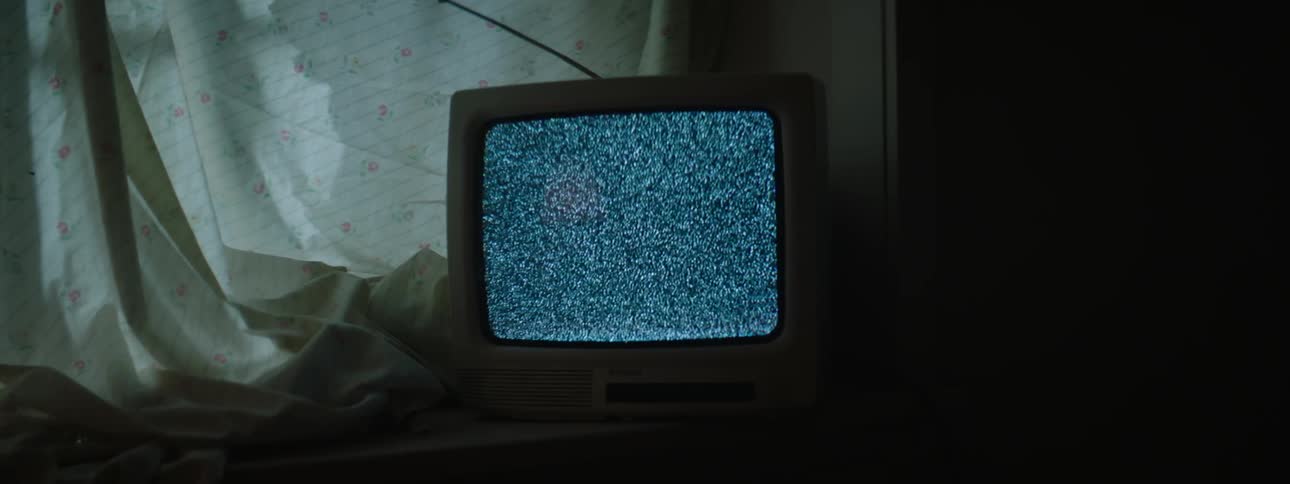 A television shows static on the screen