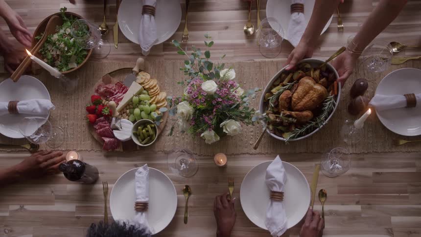 Salad and chicken are served to the table