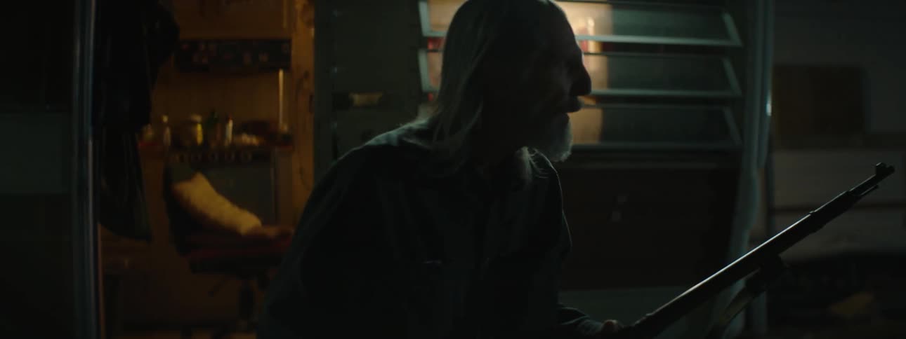A man grabs a rifle and heads outside searching his yard