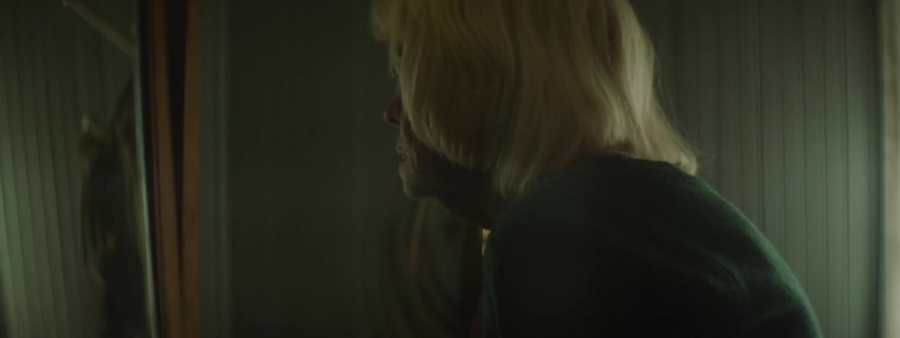 A woman slowly gets up from the bed