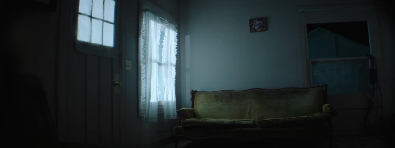 Lights from outside shine through the window and reflect on the wall