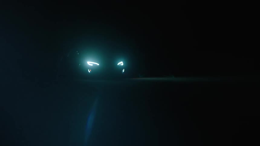Sports car driving fast in the dark night