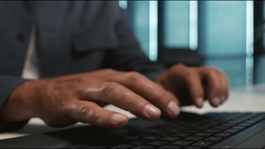 close up of fingers typing on the keyb
