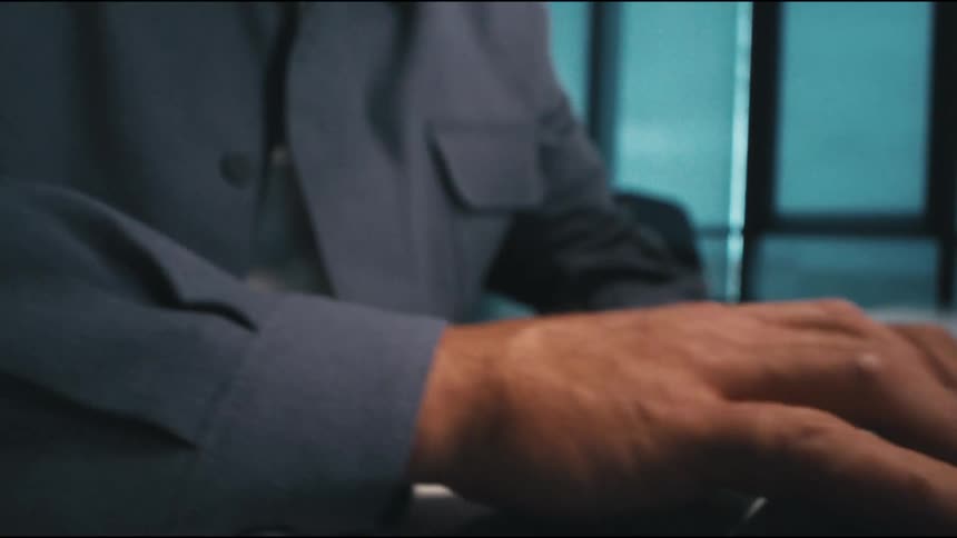 a man is thinking in the office, then gets a burst of inspiration and starts typing