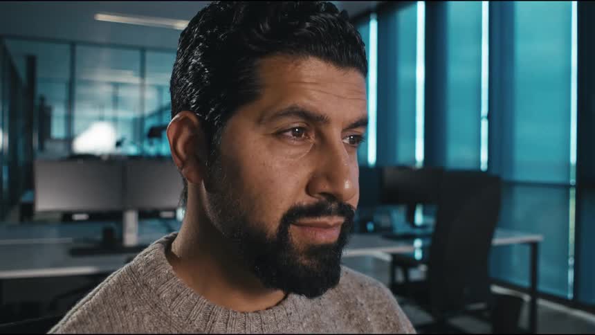 close up of dark haired man working concentrated in the office