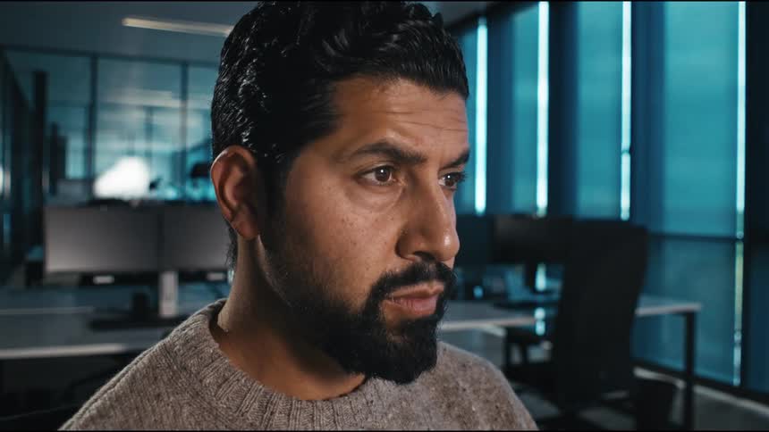 close up of man looking concentrated in an office setting, typing