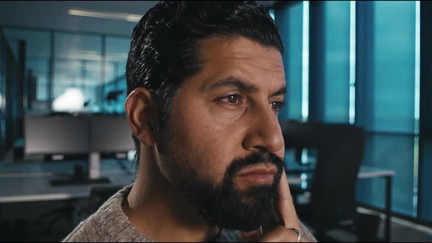 Close up portrait of a man thinking while sitting in an office