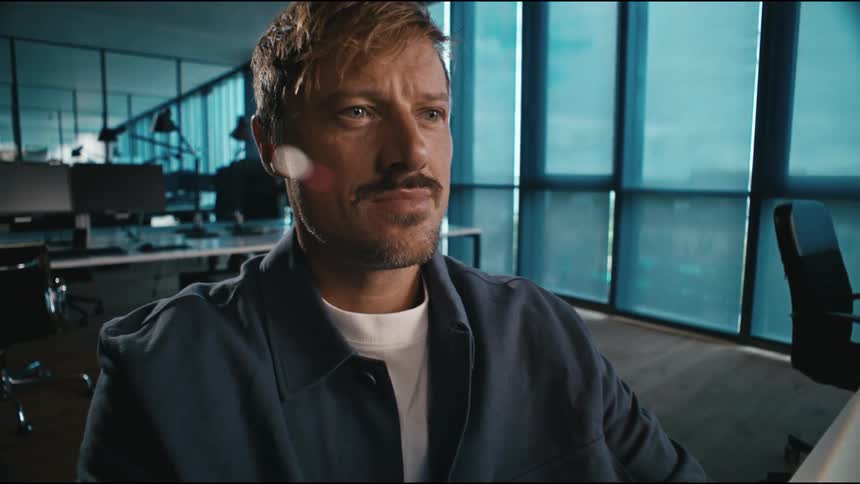 man in the office is happy and satisfied with his work