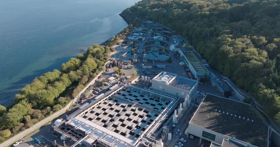 Wastewater is processed through various tanks and facilities at a large scale treatment plant