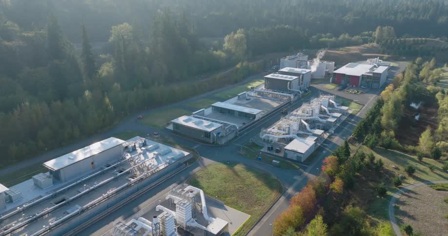 Tilt up traverse above a large complex of interconnected treatment buildings and outdoor piping at a regional wastewater facility