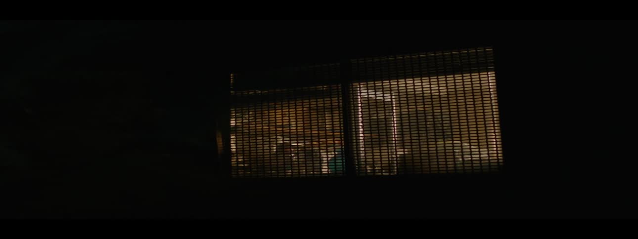 Light shines from a house window at night