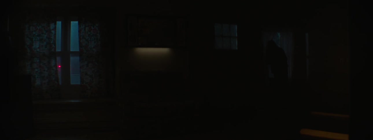 The inside of a house with something going past the windows outside
