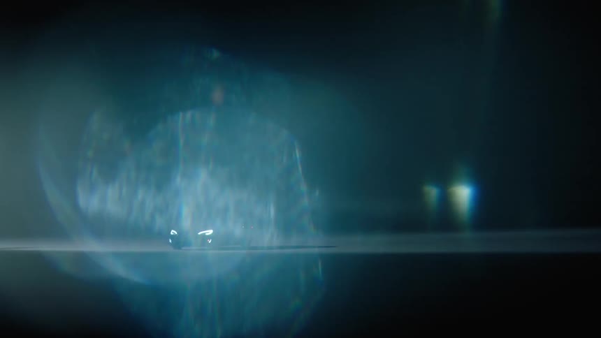 A car sitting in a parking lot at night with its headlights on