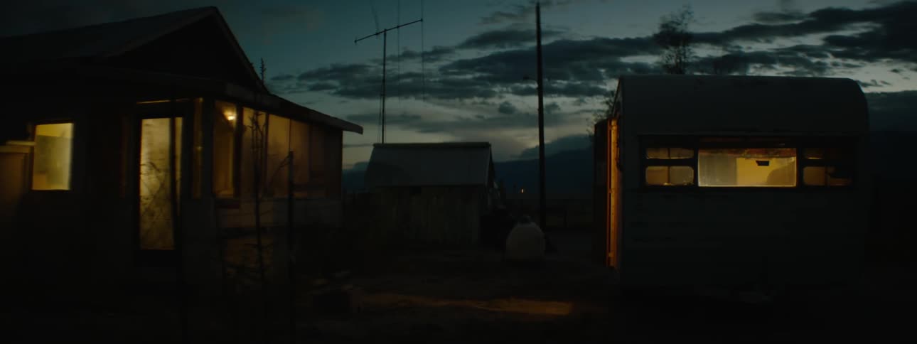 A rural house is shown at night